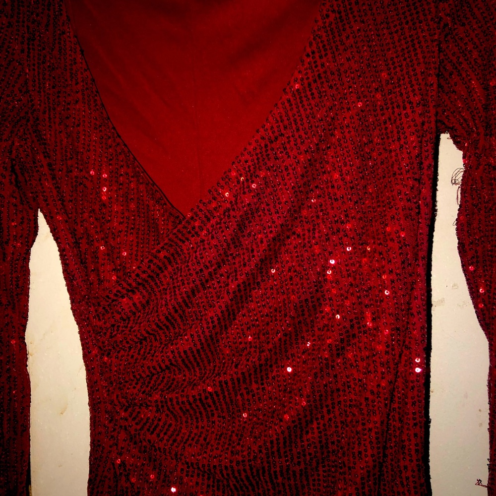 Woman’s red long sleeve dress.